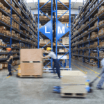 Warehouse with employees working in the foreground.