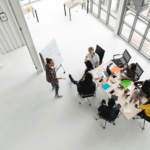 Overhead view of team collaborating at a conference table in open concept office.