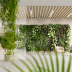 Women sitting on her phone in waiting room with a lush vertical garden.