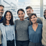 Diverse group of employees standing together and smiling.