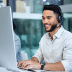 Employee with headset at their desk, providing costumer support.